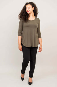 Woman walking in olive 3/4 sleeve bamboo top and black pants