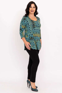 Side view of woman in turquoise and gold patterned 3/4 sleeve bamboo top with black pants