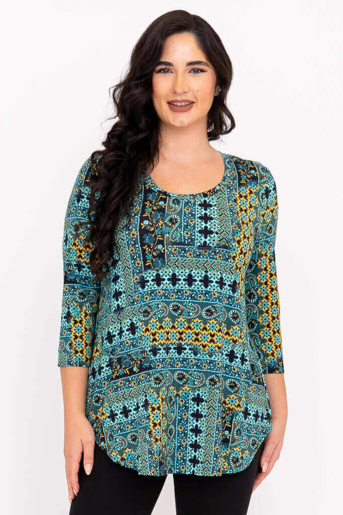 Front view of model wearing a teal and yellow patterned 3/4 sleeve bamboo tunic
