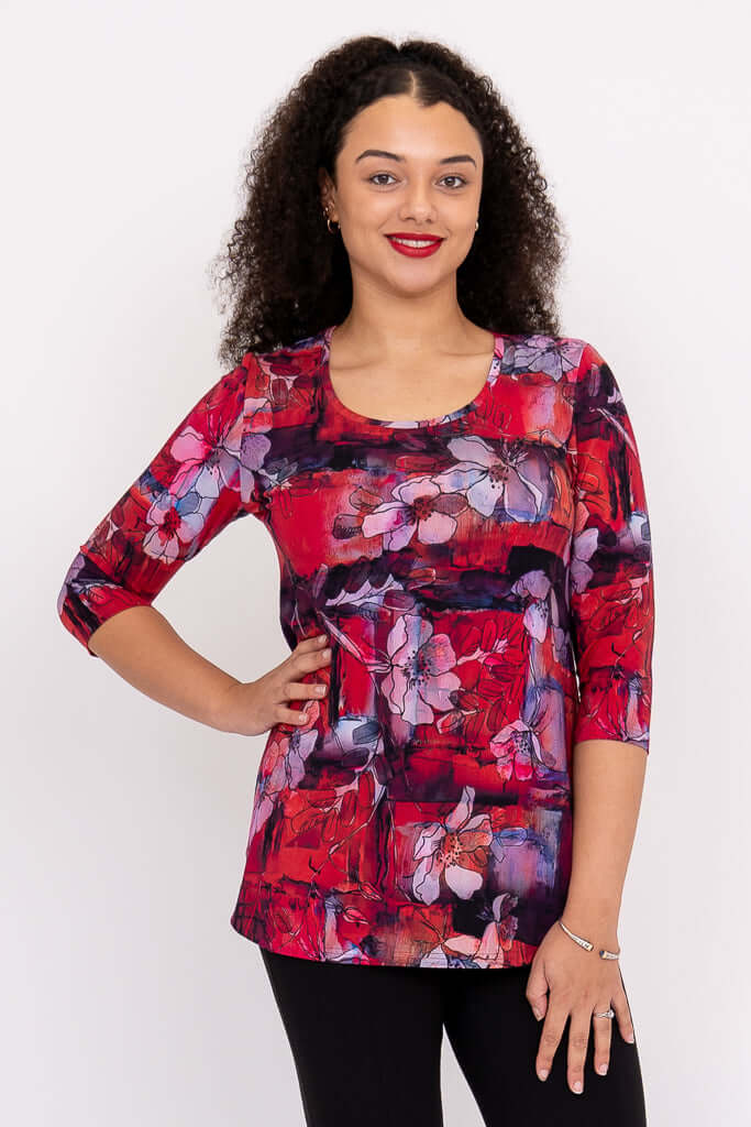 Front view of model wearing a vibrant red and purple floral Jazz 3/4 sleeve bamboo top