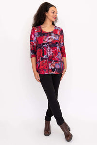 Model looking sideways in Jazz 3/4 sleeve bamboo top with red and purple floral pattern