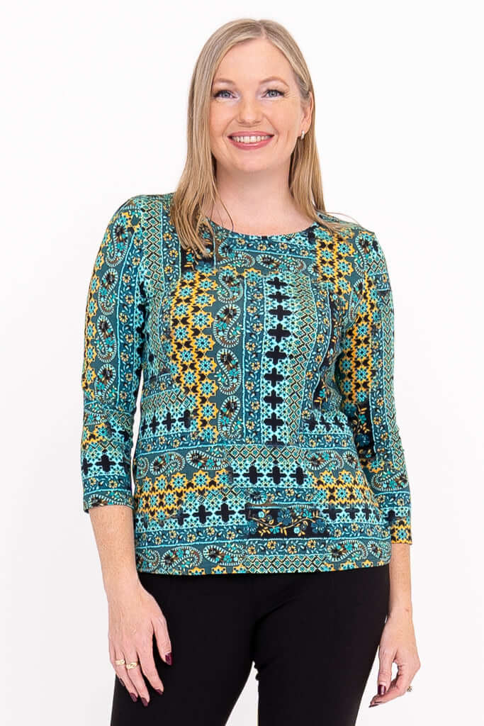 Front view of woman wearing Margorie fitted 3/4 sleeve tee in vibrant turquoise yellow print