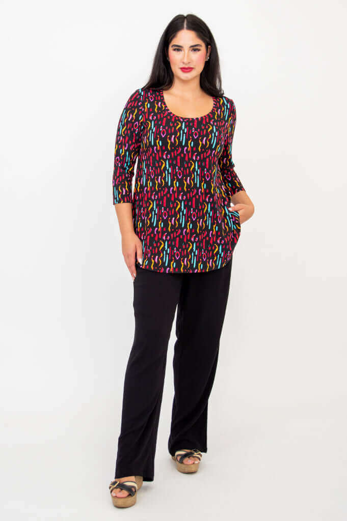 Model with hand in pocket, showcasing Jazz 3/4 Sleeve Top, prism print