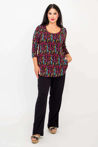 Model with hand in pocket, showcasing Jazz 3/4 Sleeve Top, prism print