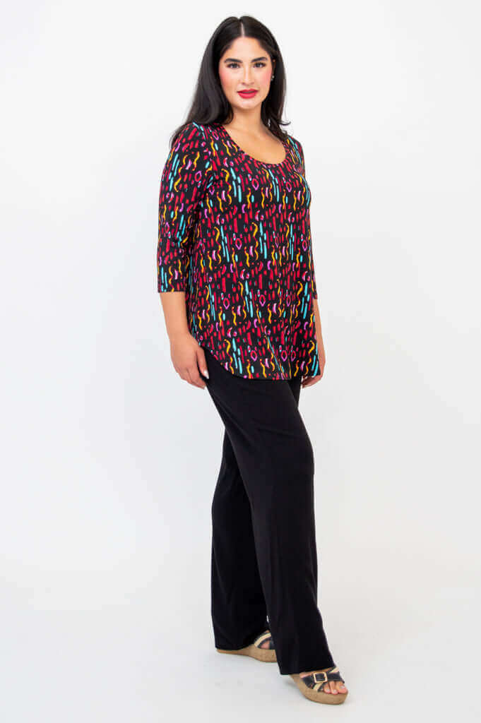 Side angle of model in Jazz 3/4 Sleeve Top with black pants