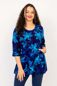 Woman wearing a blue floral Palace Blouse with 3/4 sleeves and scoop neckline
