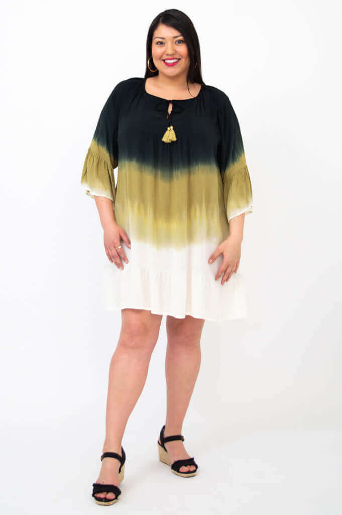 Woman modeling the Ellie Dress, showing 3/4 ruffle sleeves and keyhole tassel neckline