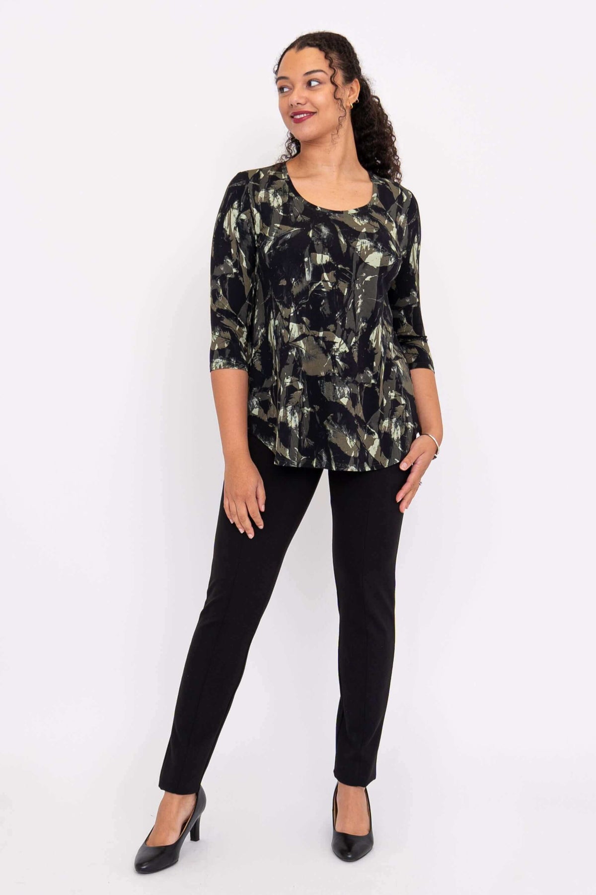 Model posing in Jazz 3/4 sleeve top with black and olive abstract print
