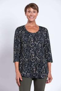 Woman wearing a black floral print 3/4 sleeve bamboo top, close-up front view