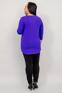 Back view of woman wearing a purple bamboo 3/4 sleeve top and black pants.