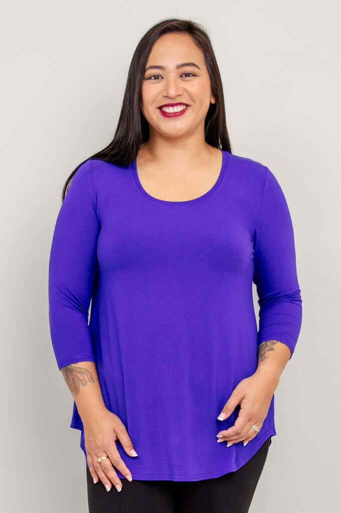 Woman wearing a vibrant purple 3/4 sleeve bamboo top, facing front.
