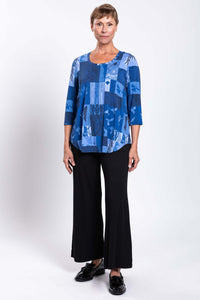 Woman modeling blue mosaic 3/4 sleeve bamboo top with black pants