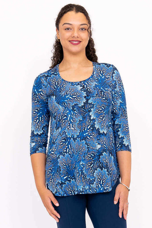 Front view of a woman wearing a blue patterned 3/4 sleeve bamboo top