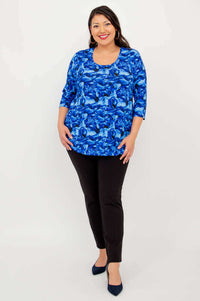 Full body view of woman in blue abstract 3/4 sleeve bamboo top and black pants