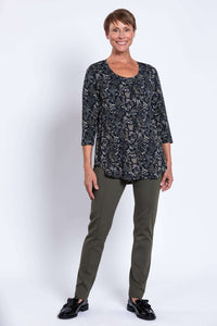 Full body view of woman in black floral 3/4 sleeve top and olive pants, front