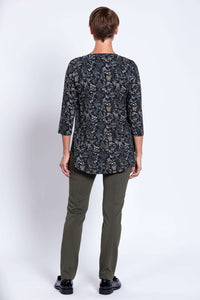 Back view of woman in black floral 3/4 sleeve bamboo top and olive pants