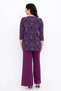 Back view of woman wearing purple damask Jazz 3/4 sleeve bamboo top and purple pants