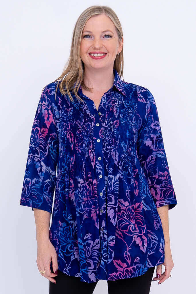 Front view of model wearing blue and pink floral Cindy smocked blouse with 3/4 sleeves