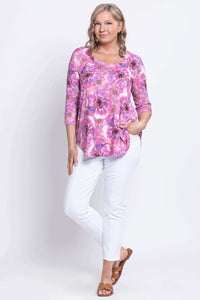 Woman modeling Scoop neck top with pink floral pattern and white pants