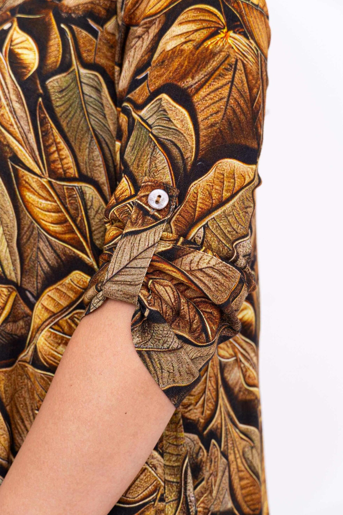 Close-up of the 3/4 tabbed cuff and botanical fabric pattern on the Celine Oversized Tunic