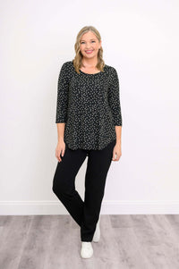 Blonde woman wearing black polka dot bamboo 3/4 sleeve top and black pants