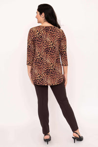 Back view of a woman wearing a leopard print 3/4 sleeve top with straight brown pants
