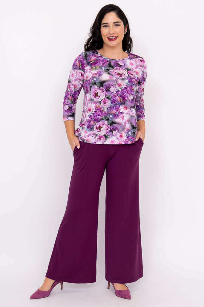 Woman in purple floral 3/4 sleeve top and purple wide-leg pants