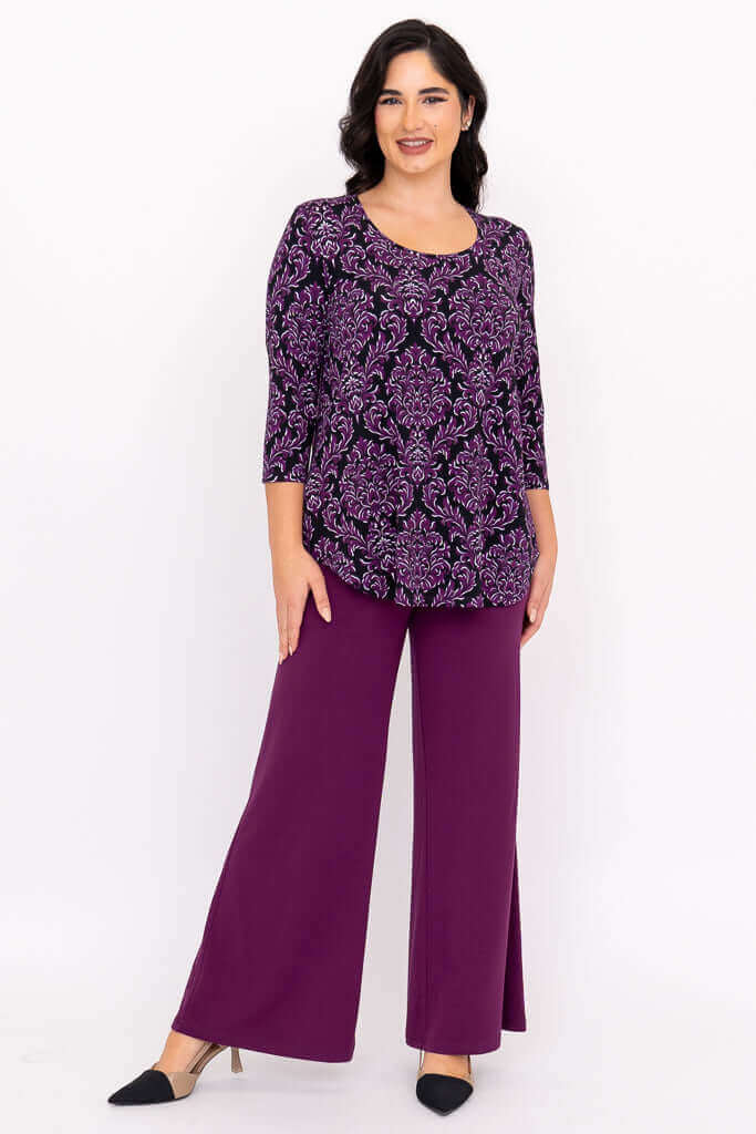 Woman in purple damask Jazz 3/4 sleeve top with matching purple pants, full body front view