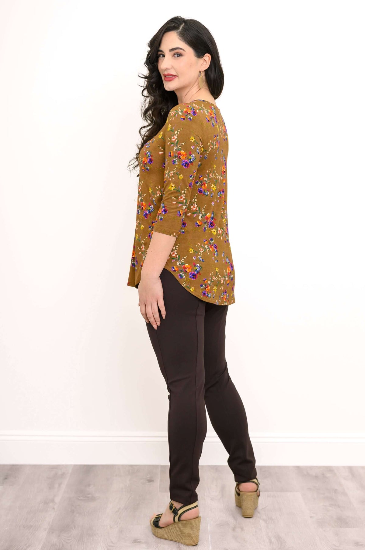 Side view of woman wearing brown floral bamboo top with 3/4 sleeves