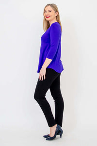 Side view of woman in purple V-neck bamboo top with 3/4 sleeves and black pants
