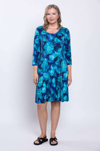 Front view of woman wearing Callie blue bamboo A-line dress with 3/4 sleeves