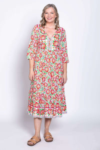 Front view of model wearing floral batik midi dress with 3/4 sleeves