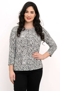 Front view of a woman wearing a black-and-white rose print fitted tee with 3/4 sleeves