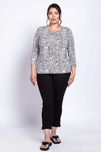 Plus size model wearing a black-and-white rose print fitted tee with 3/4 sleeves