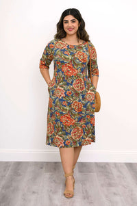 Model wearing a knee-length floral bamboo dress with pockets and 3/4 sleeves, front view