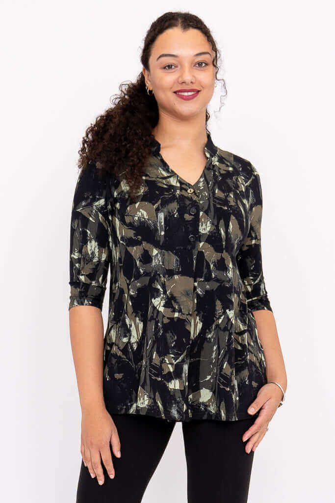 Woman wearing an abstract print bamboo top with 3/4 sleeves and V-neck, front view