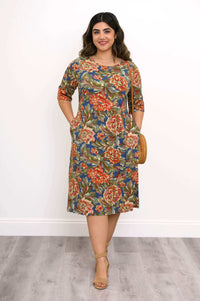 Woman wearing a knee-length floral bamboo dress with 3/4 sleeves, front view