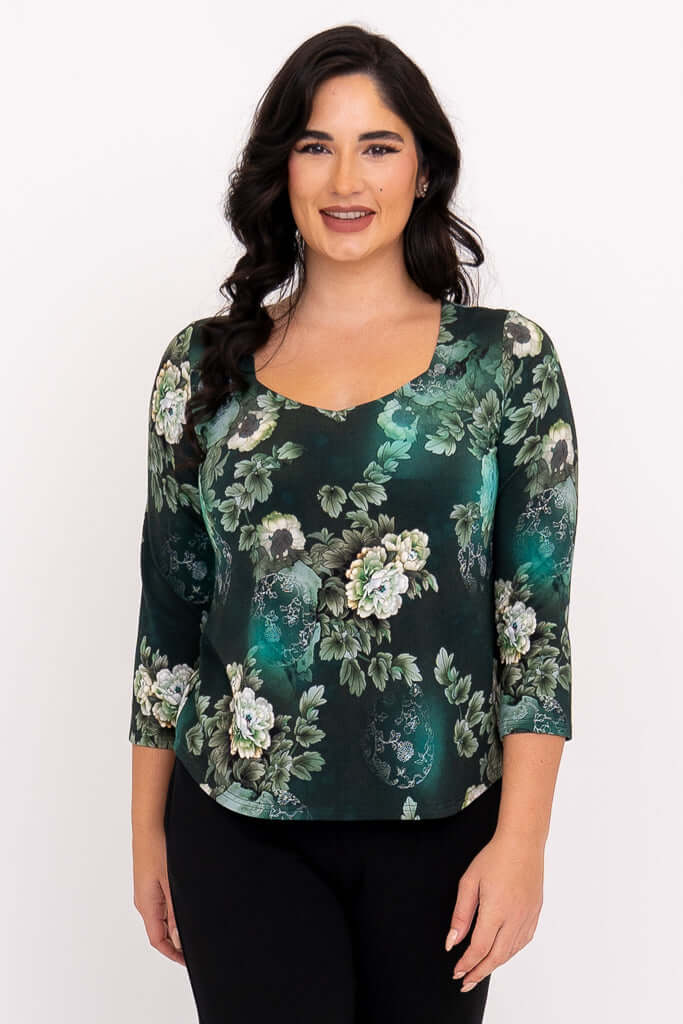 Woman wearing green floral sweetheart neckline top with 3/4 sleeves, front view
