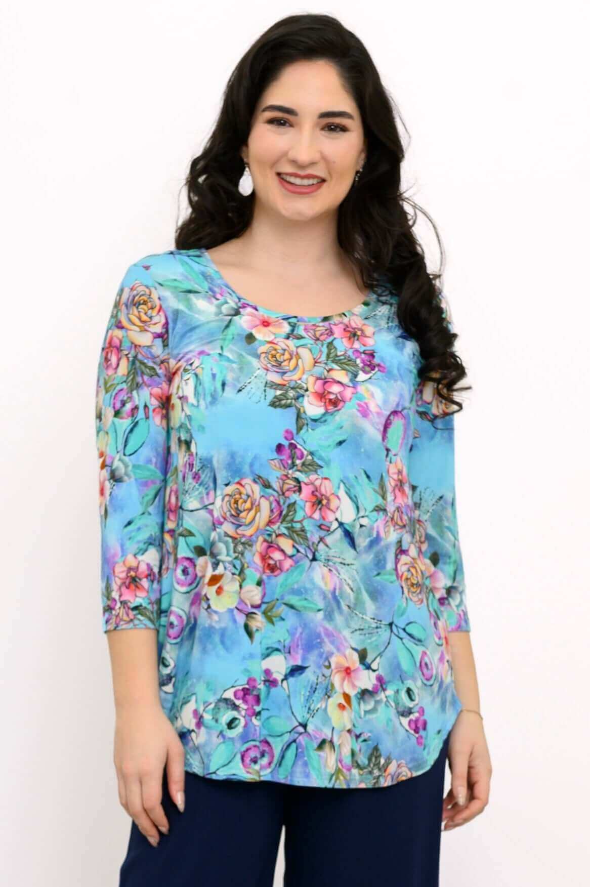 Woman wearing a blue floral bamboo top with three-quarter sleeves, front view