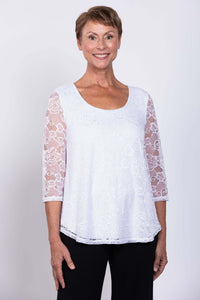Front view close-up of a woman wearing a white lace overlay top with 3/4 sleeves
