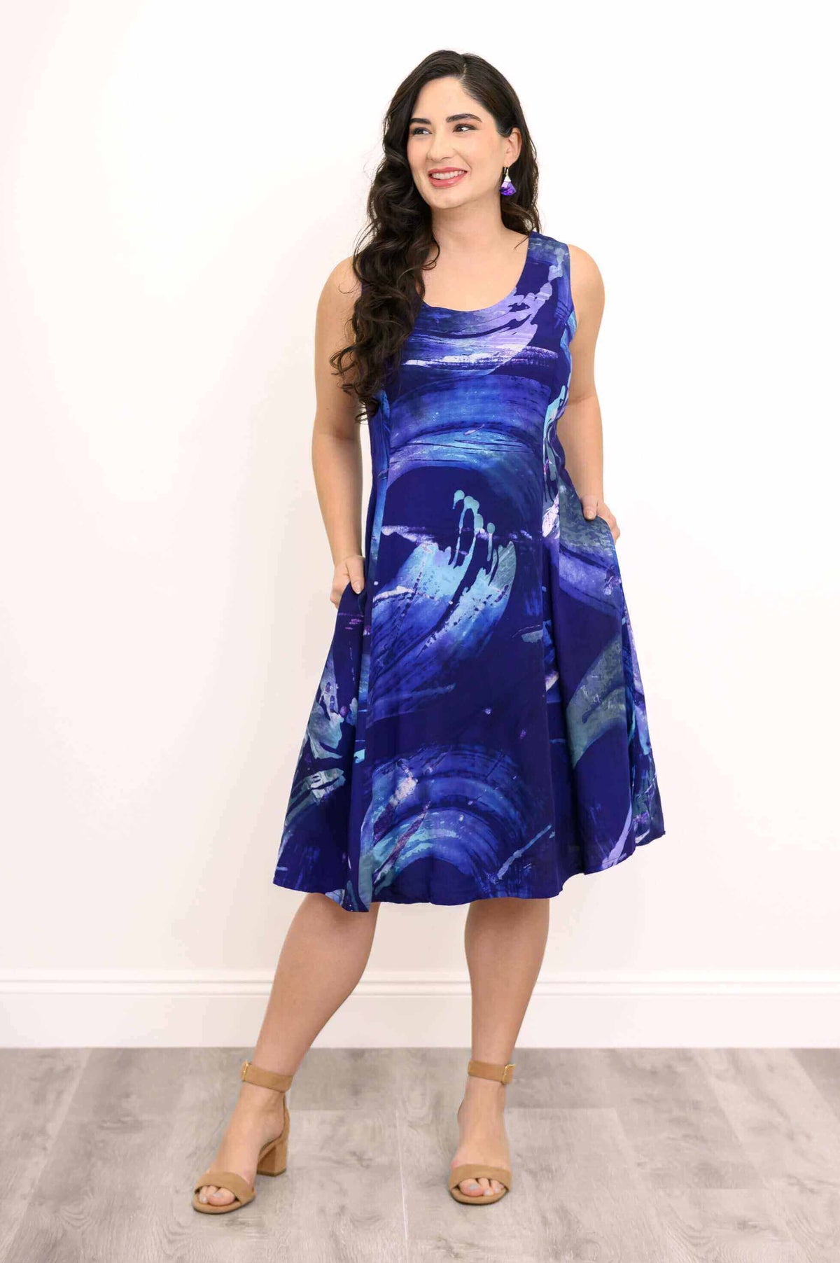 A-line dress with abstract blue pattern, front view with hands in side pockets