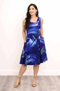 A-line dress with abstract blue pattern, front view with hands in side pockets