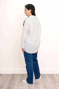 Back view of blouse showing yoke and pleats on model