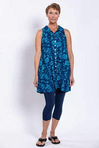 Three-quarter front view of woman modeling blue floral A-line button-up tank dress