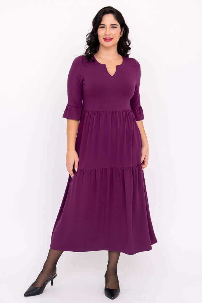 Angled front view of model wearing Bernadette Long Dress in purple bamboo blend