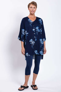 Angled front view of woman in navy Darla tunic blouse with blue rose pattern