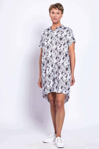 Front angled view of a woman modeling a black and white floral shirt dress