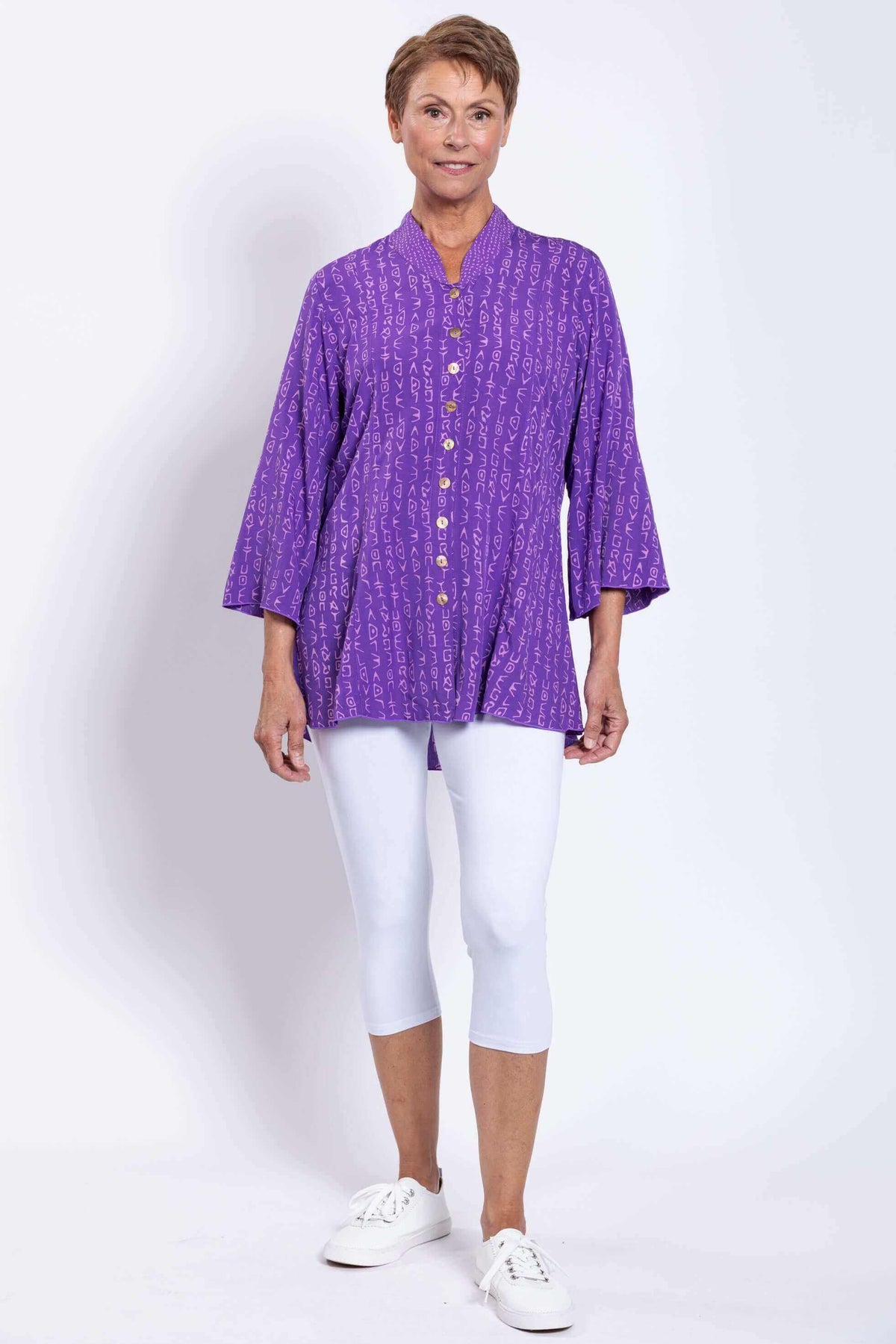 Front angled view of Mar blouse in violet featuring mandarin collar and button closure