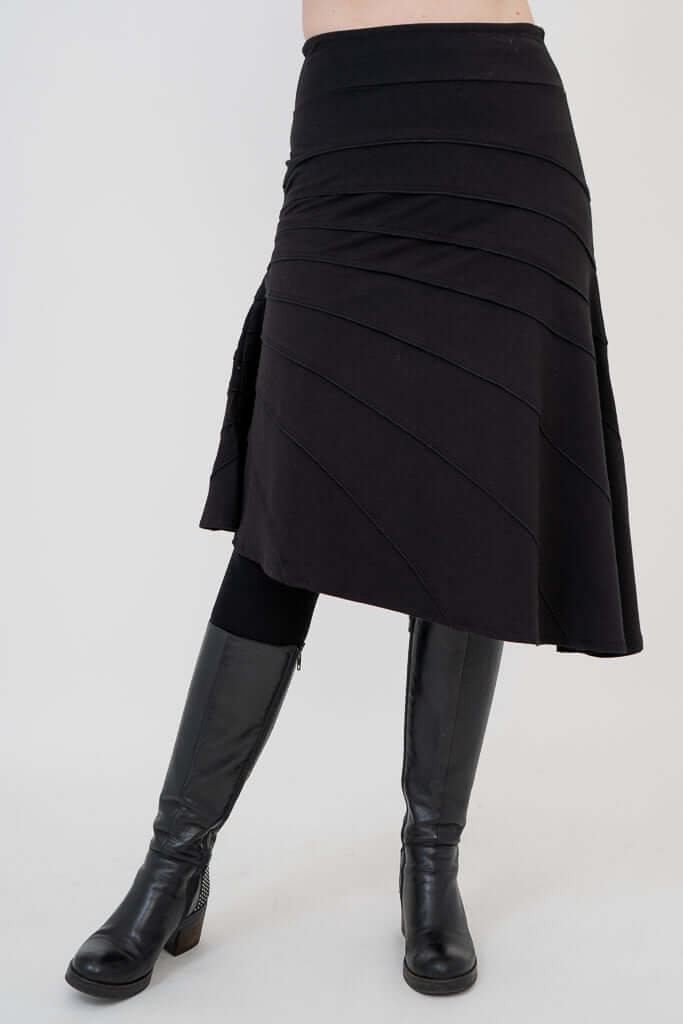 Angled front view of Beverly black skirt featuring a-line silhouette and diagonal seams