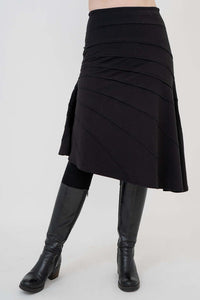 Angled front view of Beverly black skirt featuring a-line silhouette and diagonal seams